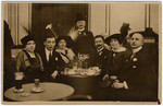 Frieda (center left) and Max (center right) Hanauer sit at a cafe with friends.