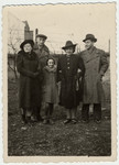Members of the Engel family stand by a fence on their after the war.