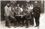 Max Hanauer stands at the far right with Russians playing chess during WWI.