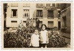 Jacqueline (left) and Manuela Mendels pose in the garden outside their apartment in Paris.