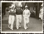 Jerzy and Nadzieja Klein walk down the street of a small town with a friend while on vacation in prewar Poland.