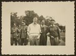 Max Schmeling poses with Glenn Morris, American gold medalist in the decathlon, and another man at the Berlin Olympics.