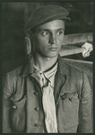 Close-up portrait of a survivor inside a barrack of the Buchenwald concentration camp.