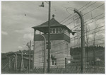 View of a watch tower and electrified fence in the Buchenwald concentration camp.