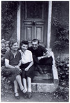 Rescuers, Albertine,Simone and Henri Voisin, rest on the steps of their home.