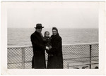 The Hochbaum family stands on the deck of the Marine Flasher while en route to the United States.
