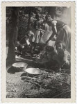Young girls and women cook coutdoors in a Jewish scout camp near Limoges.