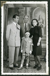 Romano Pelligrino poses with his parents, Helga and Mario and an unidentified man in front of a painting of Jesus.