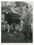 Frank Blumenstein shows his prize bull.

The inscription on the back of the photograph reads, "This is my own bull.