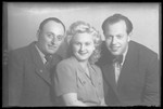 Studio portrait of Artur Grunberger and two other people.