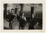 Gerta  Bagriansky and two friends play the accordion in a displaced person's camp in Graz, Austria.