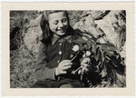 Rosian Bagriansky picks flowers on the grounds of the Selvino children's home.