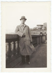 A new German-Jewish immigrant poses by a cement railing the day he arrived in New York.