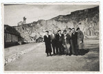 Survivors of the Gusen concentration camp pose in front of the stone quarry.
