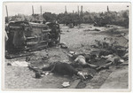Corpses and burned out military vehicles lie near a train track following a battle [probably during the German invasion of the Soviet Union].