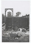 View of the gallows in front of an execution wall and watch tower in the Gusen concentration camp.