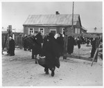 Residents pass in and out of one of the gates to the kovno ghetto.