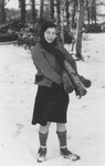 Ingeborg Haas poses in the snow outside the Chabannes children's home carrying a pile of logs.