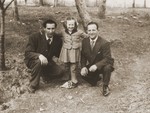 A Jewish DP child poses outside with two young men in the Cremona displaced persons camp.