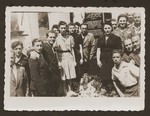 Jewish DPs from the New Palestine displaced persons camp gather around a memorial erected to the Jewish victims of the Nazis.