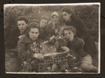 Necha Ajzen poses with her daughters at her husband's grave in Gorky.