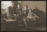 Meir and Shmuel Kats pose in their livingroom with their children Rachel and Bernhard.