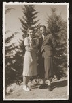 Jewish refugees, Edwarda Wang and Fritz Kohn, stand near a pine grove in Istanbul.