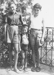 Three Jewish refugee children pose on the terrace of the children's home in Izieu.