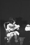 Diane Popowski, a Jewish child from Luxembourg, who was adopted by the Pallarès family after she was rescued from a nearby internment camp, sits on a chair holding a doll.