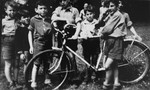 Jewish children at the OSE home in Draveil stand next to a bicycle.