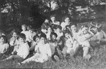 Jewish refugee children sit in the grass outside the OSE children's home in Poulouzat.
