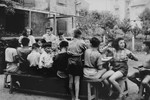 Children at an OSE home enjoy a meal outside.