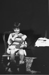 Diane Popowski, a Jewish child from Luxembourg, who was adopted by the Pallarès family after she was rescued from a nearby internment camp, sits on a chair holding a doll.