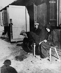 Three Hungarian-Jewish women survivors sit outside their barracks in Penig, a sub-camp of Buchenwald.