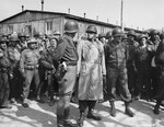 General George S. Patton (with his back to camera) converses with General Omar Bradley during their tour of the newly liberated Ohrdruf concentration camp.