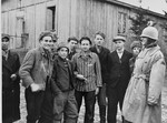Colonel Hayden Sears (right) poses with a group of survivors in the newly liberated Ohrdruf concentration camp.