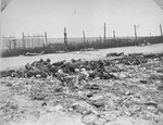 Charred corpses lie among the ruins of a razed barracks in Leipzig-Thekla, a sub-camp of Buchenwald.
