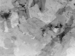 American investigators study corpses exhumed from a mass grave in Berga-Elster, a sub-camp of Buchenwald.