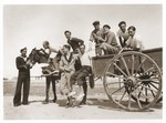 Sam Rouben (in the white shirt) poses with a group of friends on a horse-drawn wagon.