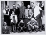 Group portrait of members of the Franses family, a Jewish refugee family from Skopje, Macedonia, with the Albanian family (the Kasapis) that sheltered them in Tirana, Albania.