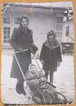 Olga Litman walks down a snowy street with her two daughters.