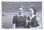 Two women [probably Roza Kwar and Krystyna Moskalik] standing in a field.