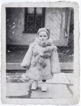 Portrait of three-year-old Estera Horn wrapped in a fur coat .