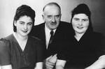 Group portrait of Jewish survivors in Lodz.

Pictured from left to right are: Rozalia Laks, her uncle Alexander Laks, and her cousin Anja Ptashnik.
