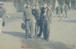 Three former prisoners pose on the main street of the newly liberated Dachau concentration camp.
