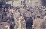 Former prisoners assemble in front of a barracks in the newly liberated Dachau concentration camp.