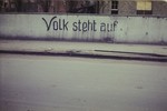 German slogan painted on a wall in or near the newly liberated Dachau concentration camp that reads, "People, rise up."