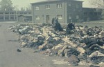 Survivors search through a huge pile of prisoner clothing in the newly liberated Dachau concentration camp.