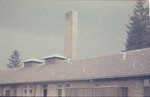 Partial view of the crematorium, focusing on the chimney, in the newly liberated Dachau concentration camp.