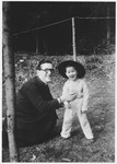 Father Edouard Robert poses next to Marcel (the cousin of Hena Kohn), a young Jewish child in hiding who he is protecting.